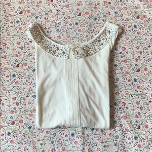 Sleeveless top with jeweled collar
